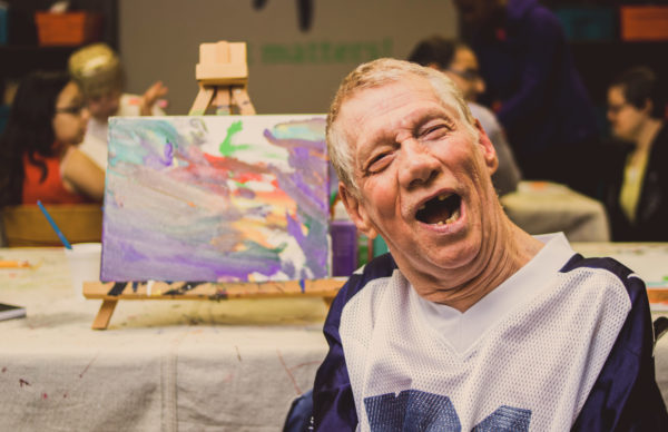 smiling with his painting