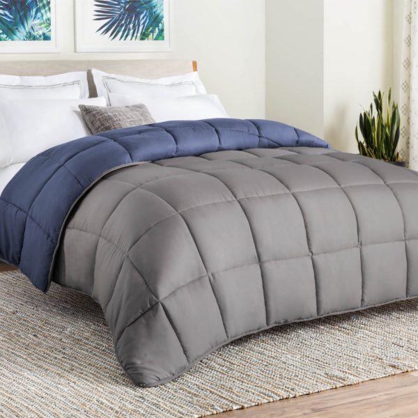 Blue and grey comforter on bed