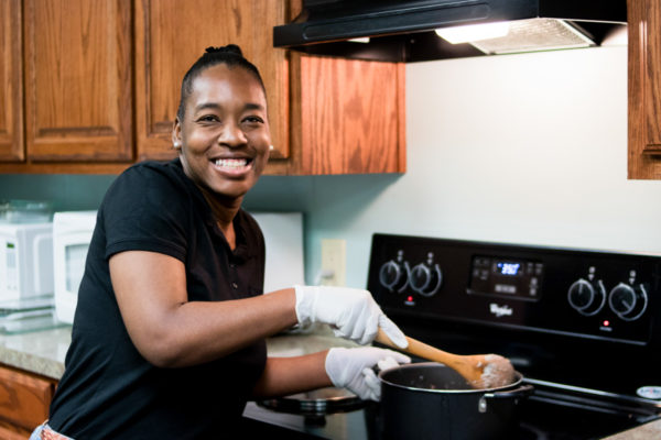Woman stirring the pot and smiling