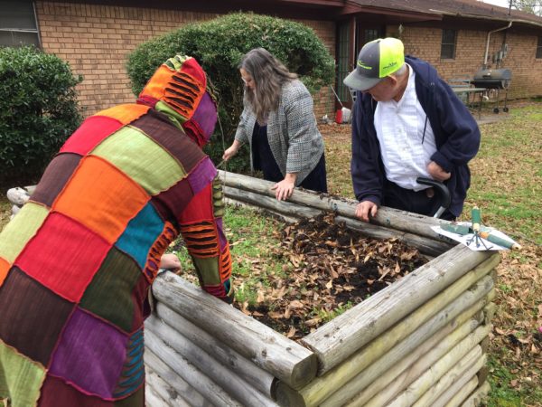 Group cleaning the planter box