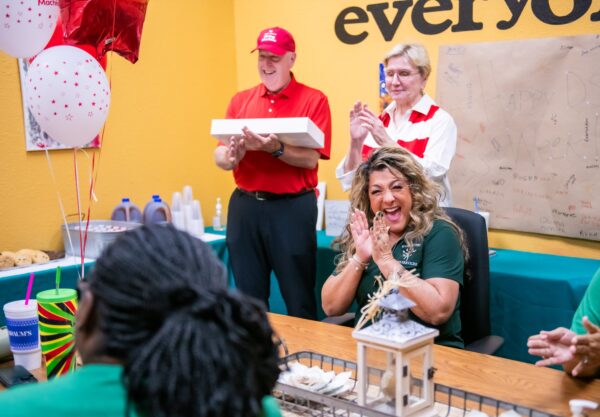 Happy and smiling group from Evergreen talking with representatives from the Giving Machine