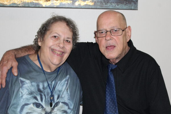 Sandra and Charles, married for 11 years, live at Evergreen Life Services' community home in Texarkana, Texas. Sandra is seated on the left and Charles is seated on the right. 